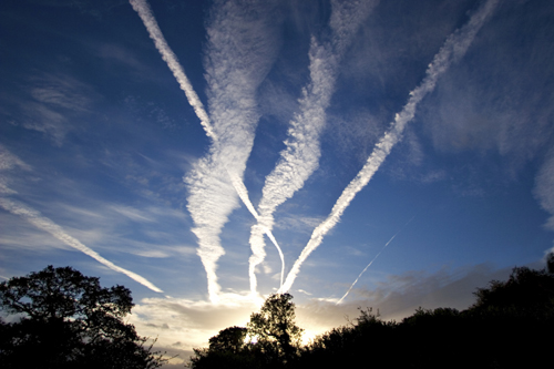 Photo of the sky with streaks left by airplanes/jets.