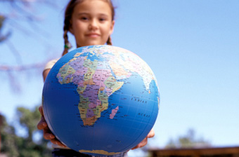 Climate Change - young girl holding out a globe.